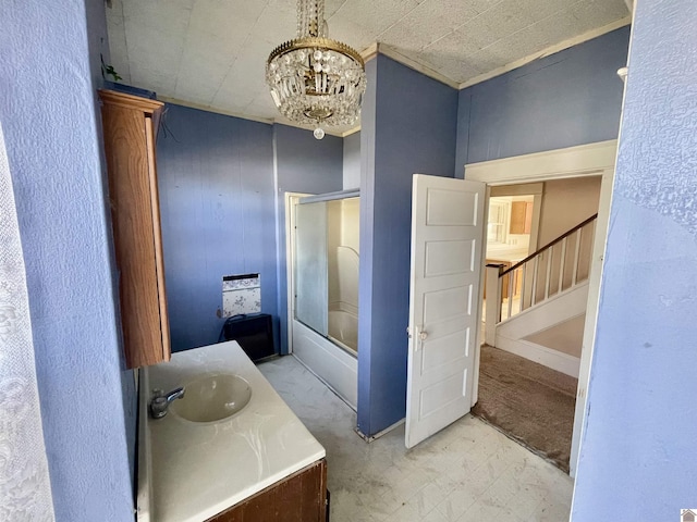 full bath with tile patterned floors, combined bath / shower with glass door, vanity, and a notable chandelier