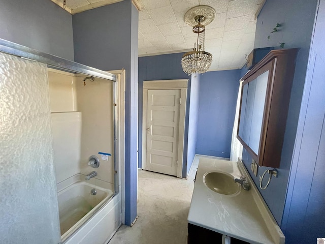 bathroom with tub / shower combination, vanity, and an inviting chandelier