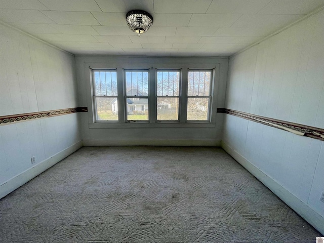 empty room featuring carpet flooring and baseboards