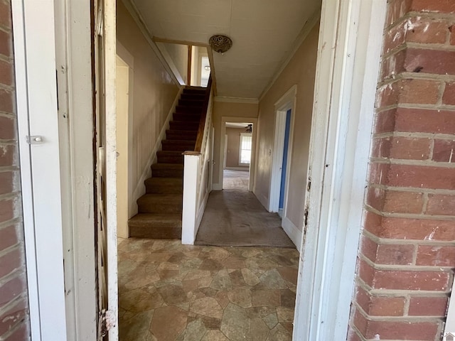 hall with crown molding and stairs