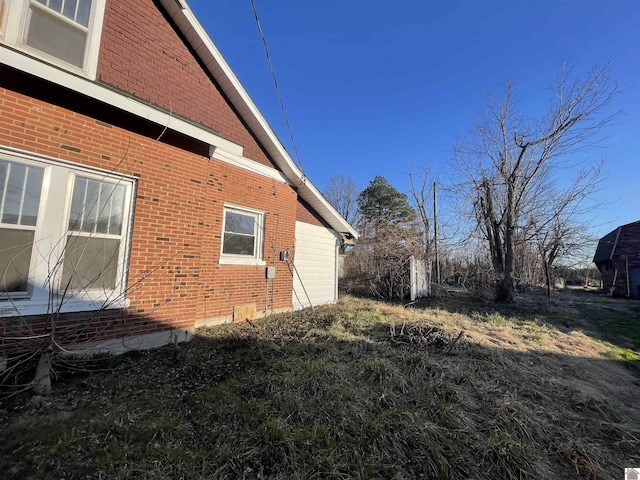 view of side of home with brick siding