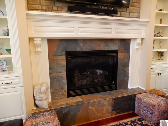 room details with a tiled fireplace and built in features