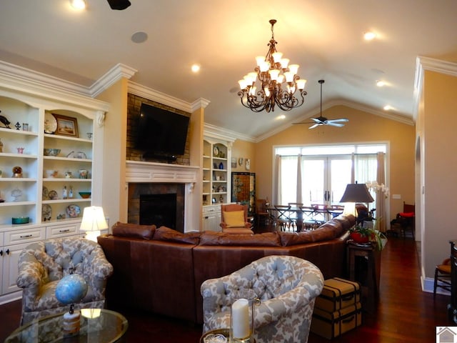 living room featuring lofted ceiling, ornamental molding, dark wood-style flooring, and a tile fireplace