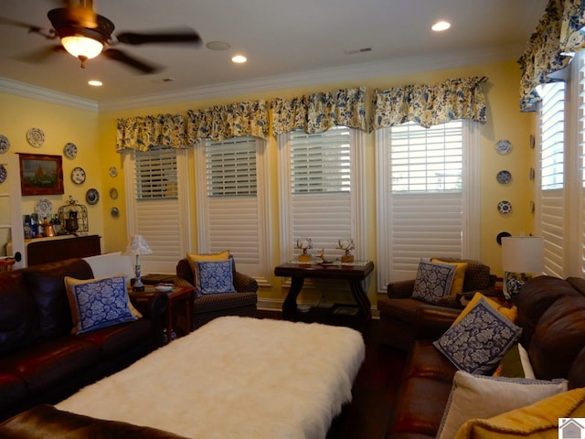 living area with a ceiling fan, recessed lighting, visible vents, and ornamental molding