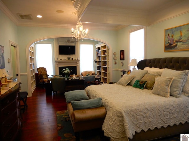 bedroom with dark wood-type flooring, multiple windows, a fireplace, and arched walkways