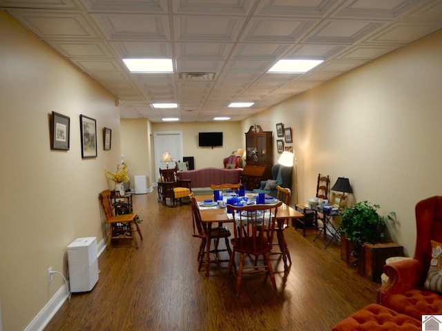 dining room with visible vents, baseboards, and wood finished floors