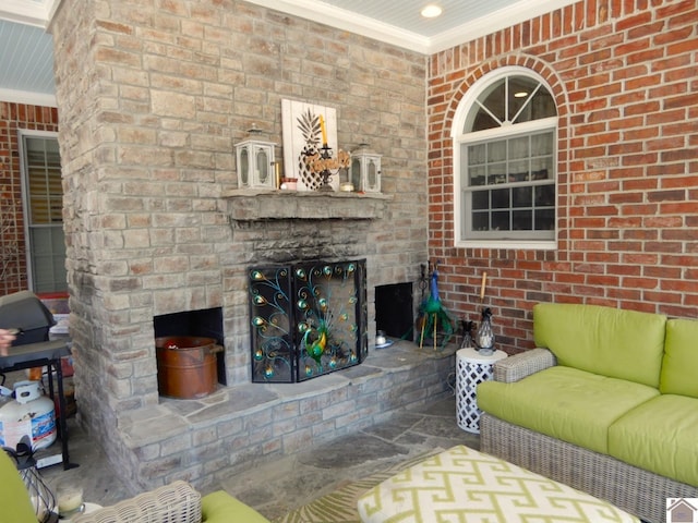 unfurnished living room featuring recessed lighting, a fireplace, brick wall, and crown molding