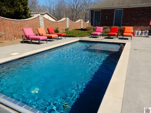 view of swimming pool featuring a fenced in pool, a patio, and fence