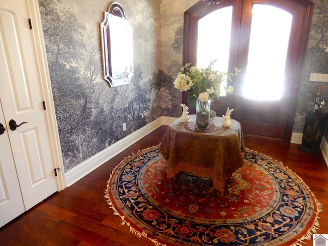 entryway featuring wallpapered walls, baseboards, and wood finished floors