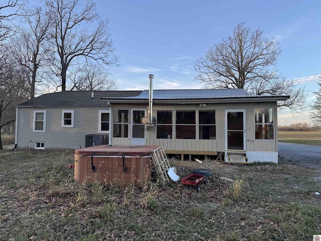 1049 Kirksey-Almo Rd, Murray, KY 42071 - rear view of house featuring central air condition unit, a sunroom, and a hot tub