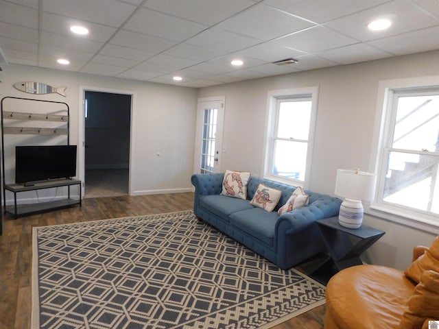 living area with recessed lighting, wood finished floors, visible vents, and a paneled ceiling