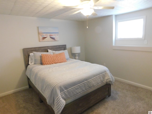 carpeted bedroom featuring baseboards and ceiling fan