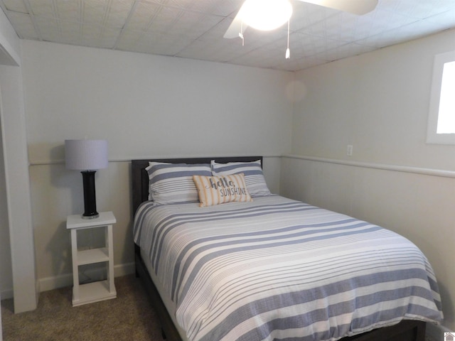 carpeted bedroom featuring a ceiling fan and baseboards