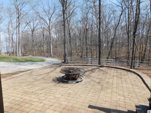 view of patio / terrace featuring fence and an outdoor fire pit