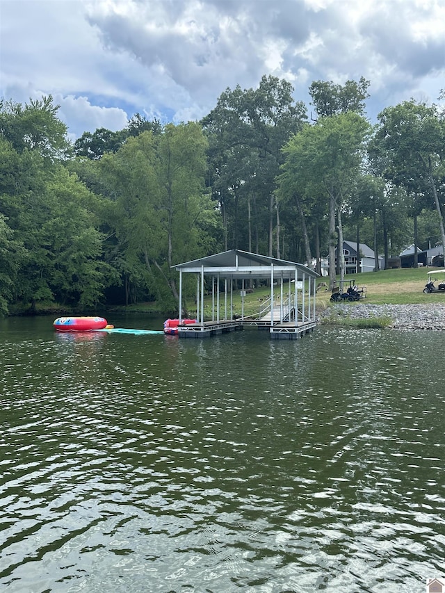 dock area with a forest view and a water view