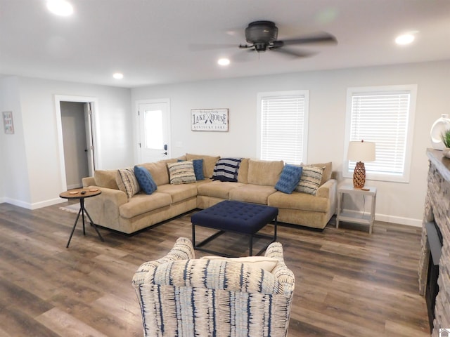 living room featuring dark wood finished floors, recessed lighting, and baseboards