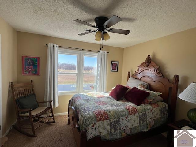 bedroom featuring baseboards, a textured ceiling, ceiling fan, and carpet flooring