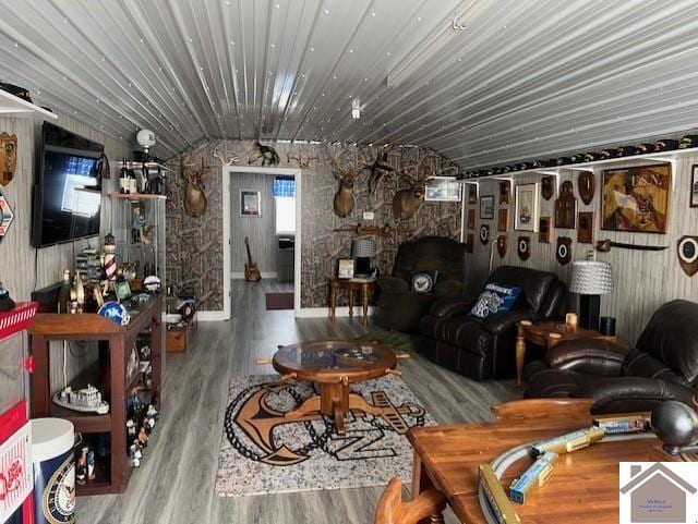 living area featuring lofted ceiling and wood finished floors