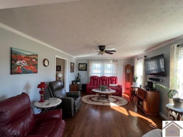 living area with a textured ceiling, wood finished floors, a ceiling fan, and ornamental molding