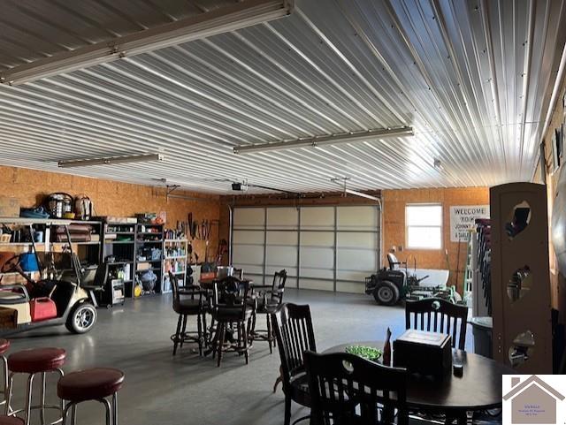 garage featuring metal wall and a garage door opener