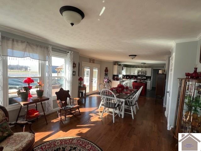 dining room featuring french doors, dark wood-style floors, and ornamental molding