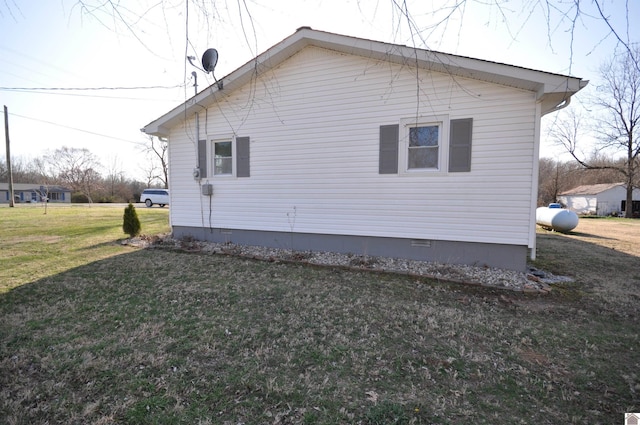 view of side of property featuring crawl space and a yard