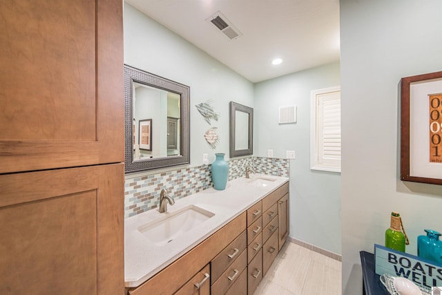 full bathroom with a sink, visible vents, tasteful backsplash, and double vanity