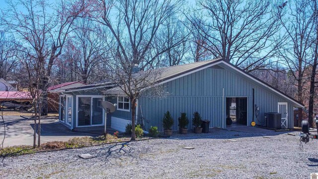 view of outbuilding featuring cooling unit and a sunroom