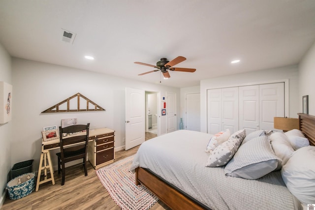 bedroom with recessed lighting, visible vents, light wood-style floors, and a closet