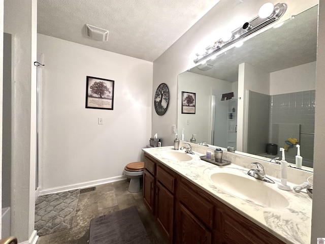 full bathroom featuring a sink, visible vents, a textured ceiling, and a stall shower