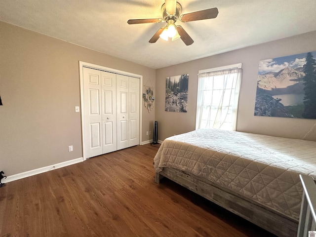 bedroom featuring wood finished floors, baseboards, a closet, and ceiling fan