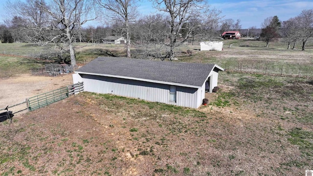 view of side of home featuring an outdoor structure and fence