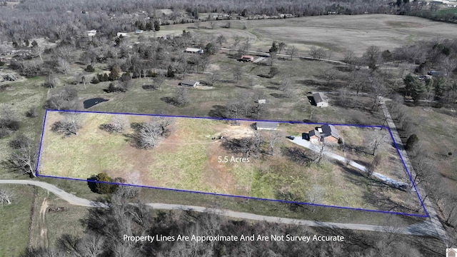 birds eye view of property with a rural view