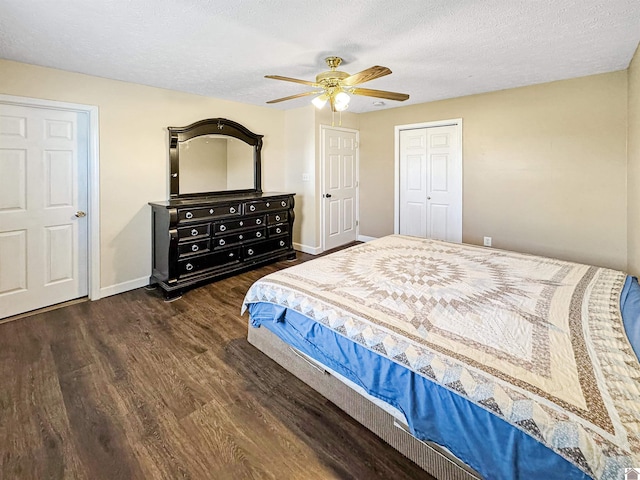 bedroom with ceiling fan, baseboards, a textured ceiling, and wood finished floors