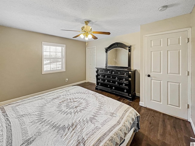 bedroom with baseboards, dark wood-type flooring, ceiling fan, and a textured ceiling