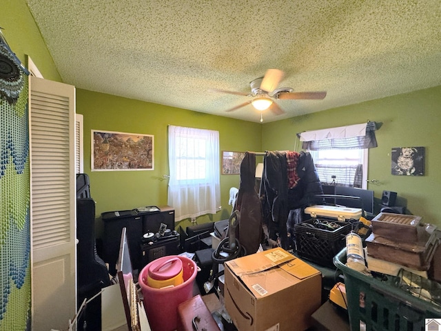 interior space featuring a textured ceiling and ceiling fan