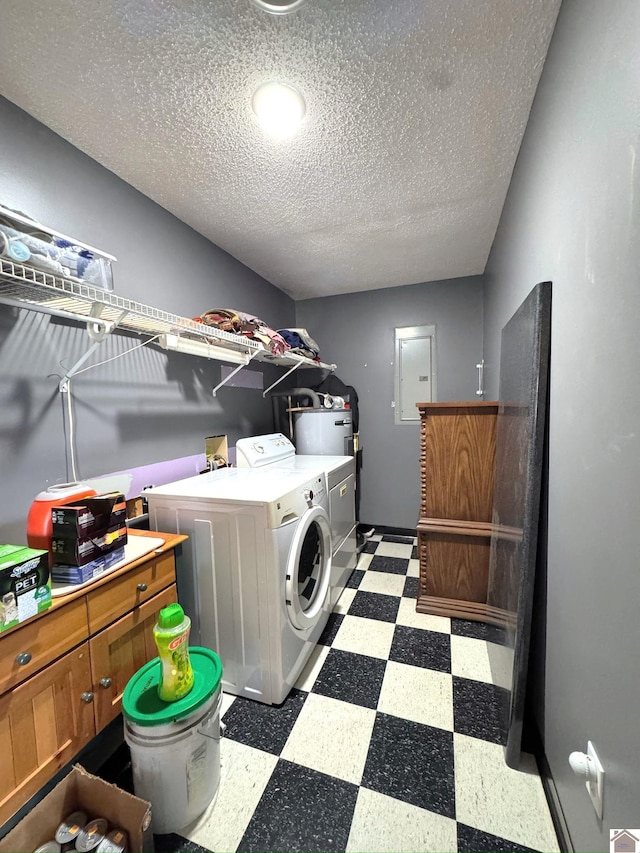 laundry area featuring electric panel, water heater, a textured ceiling, tile patterned floors, and independent washer and dryer