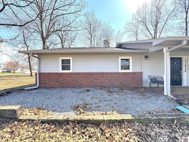 view of side of property with brick siding