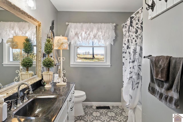 bathroom featuring vanity, a shower with curtain, baseboards, tile patterned floors, and toilet