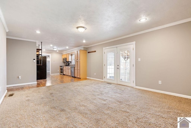 unfurnished living room featuring crown molding, baseboards, light carpet, french doors, and a textured ceiling