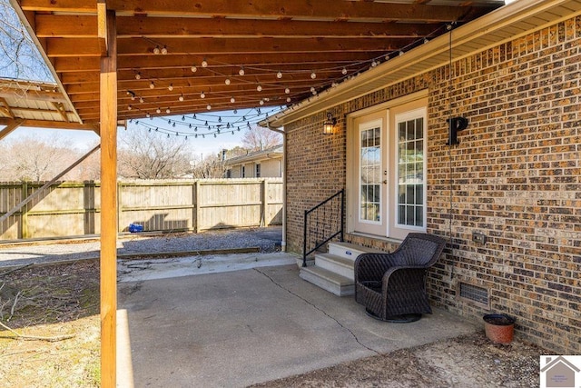 view of patio featuring entry steps and fence