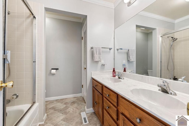 bathroom with double vanity, ornamental molding, shower / bath combination with glass door, and a sink