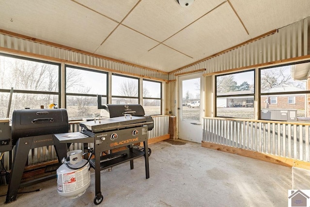 sunroom / solarium featuring vaulted ceiling