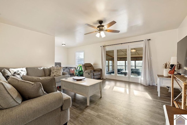 living room with a ceiling fan and wood finished floors