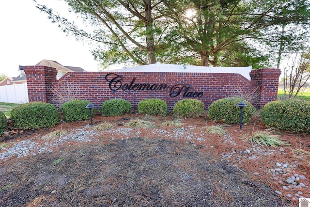 community / neighborhood sign with fence