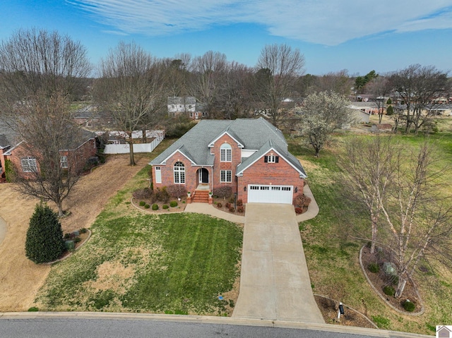 view of front facade featuring a front yard, brick siding, and driveway