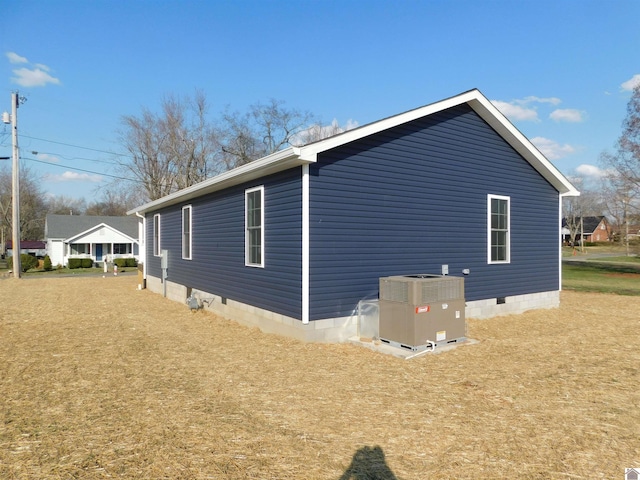 view of side of home with central AC