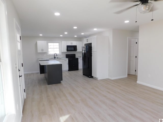 kitchen featuring black appliances, a sink, recessed lighting, light countertops, and ceiling fan