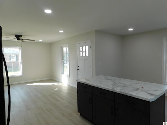 kitchen featuring a ceiling fan, dark cabinetry, recessed lighting, light wood-style floors, and baseboards