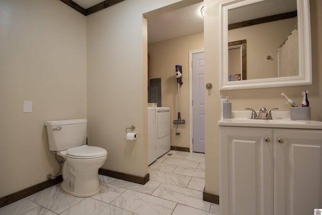 full bath featuring toilet, marble finish floor, washer and clothes dryer, baseboards, and vanity